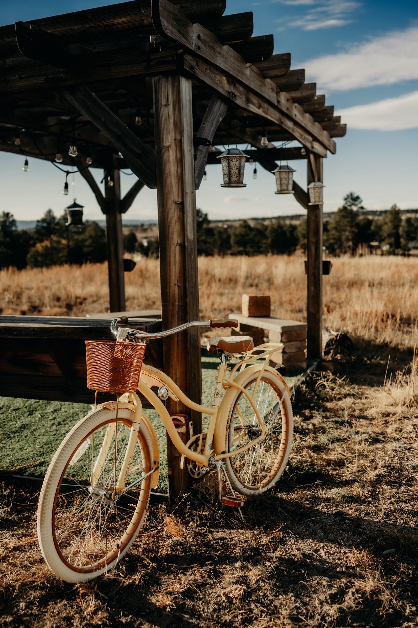 Yellow bicycle near a wooden pergola in Colorado landscape