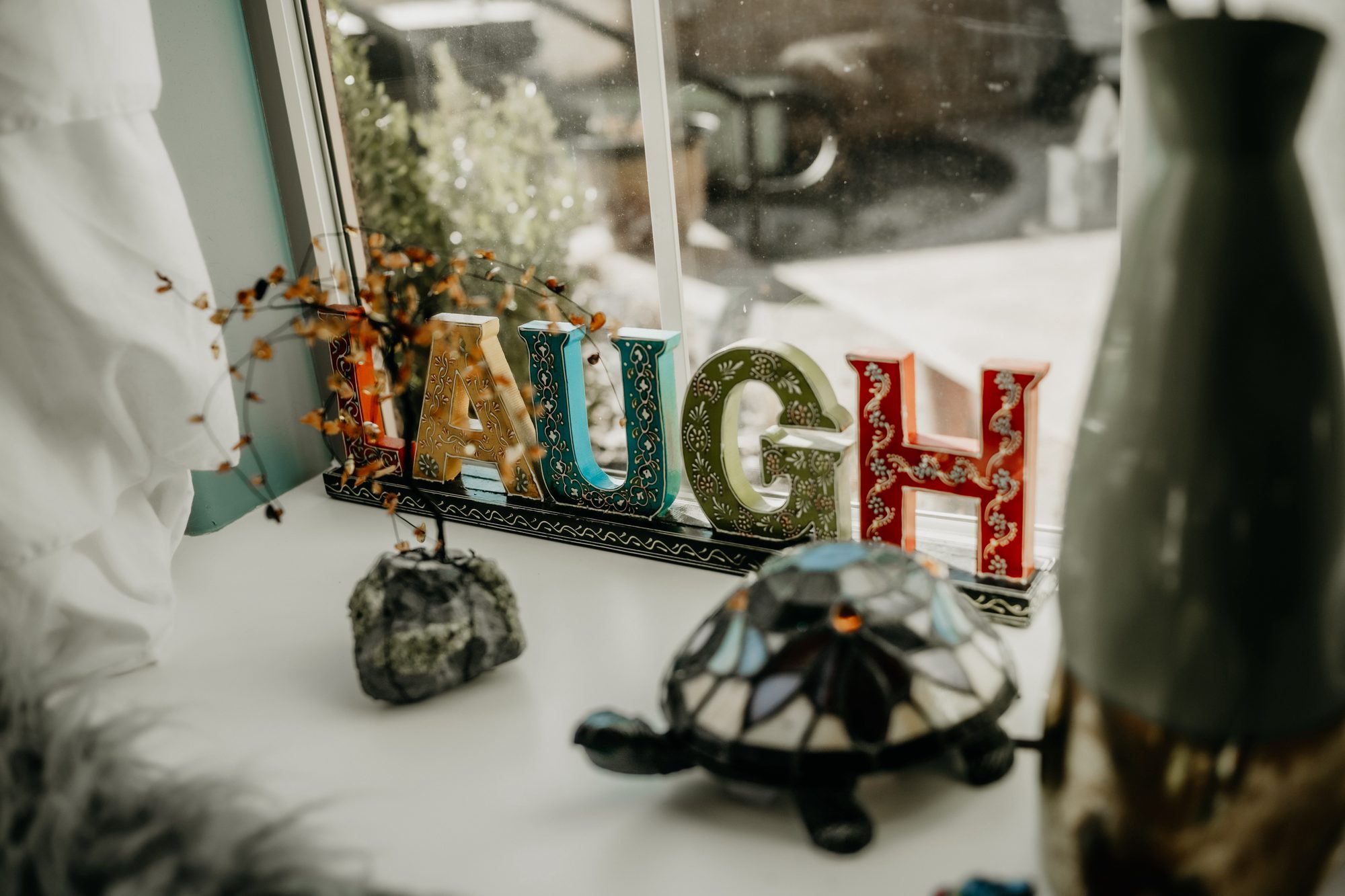 Colorful LAUGH sign on Katharine's office windowsill